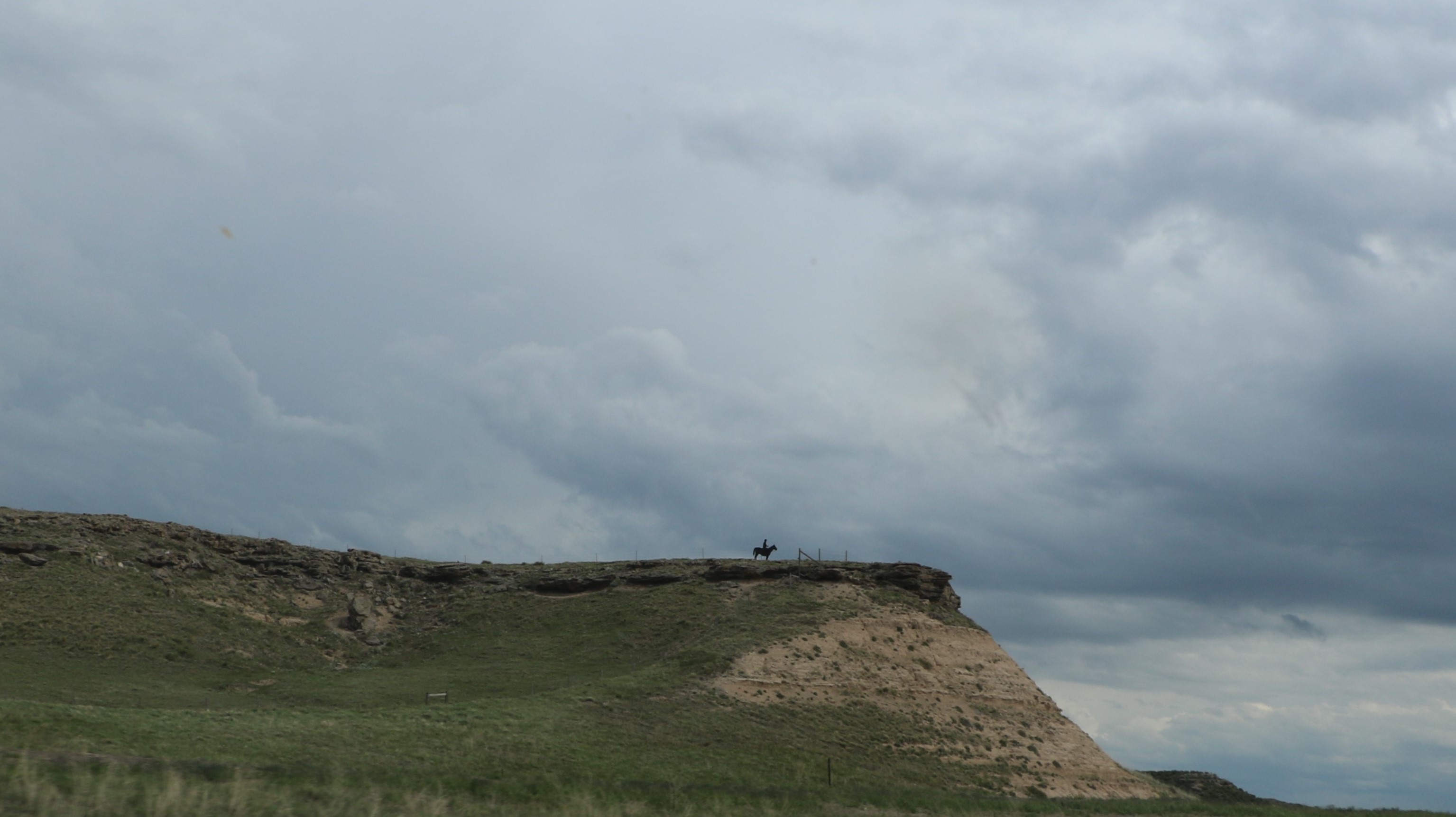 1O2A5298 I-25 S Chugwater, WY horse & rider figure on mt